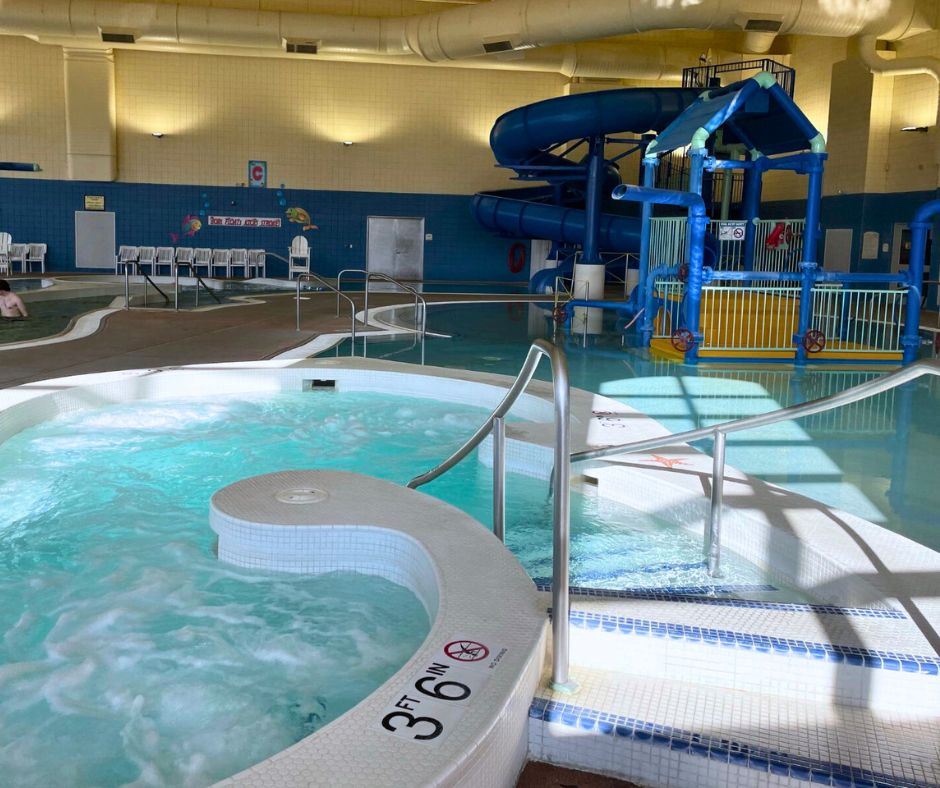 A photo of the hot tub showing the feature pool and water slide in the background. 