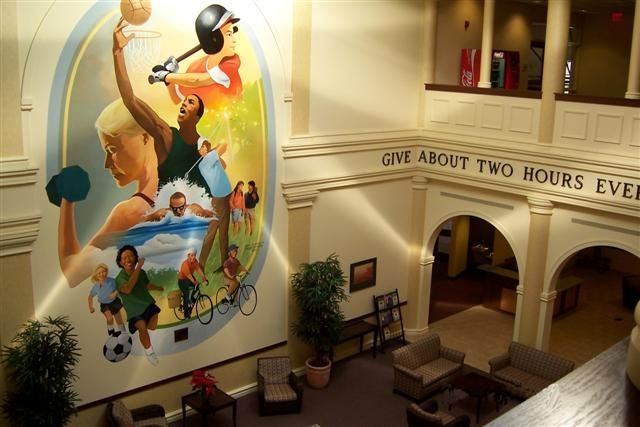 Parks and Recreation Center lobby with a mural on the wall and chairs  