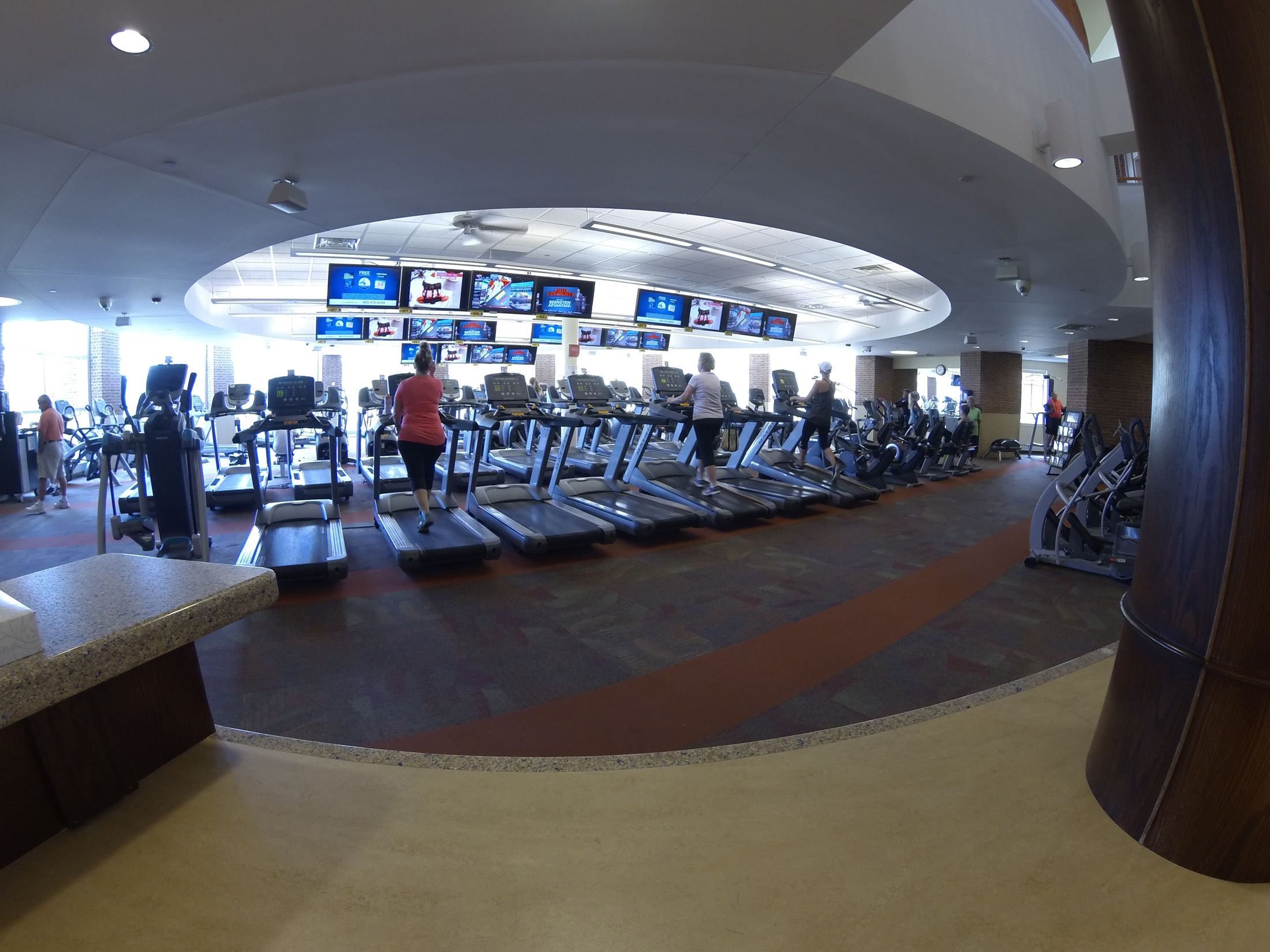 A resident walking on a treadmill at the Parks and Recreation Fitness Center