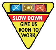 Yellow road sign with the words "Slow Down & Give Us Room to Work"